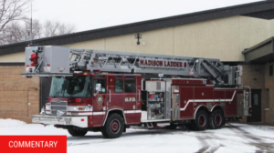 a fire truck pulling out of the station during the winter